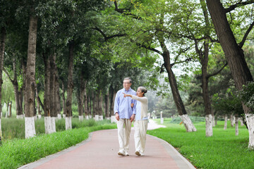 Fototapeta na wymiar Happy old couple walking in the park