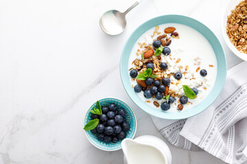 Blueberry and almond granola with greek yogurt, cottage cheese and fresh berries, top view