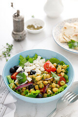 Mediterranean Greek and chickpea salad with fresh vegetables and feta cheese