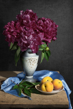 Beautiful still-life. Wonderful peonies with peaches. Eleganse drapery. This photo - good illustration for book or journal. It a summer still-life.