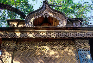 Part of the Facade with decor. Old Russian wooden house in an urban environment.