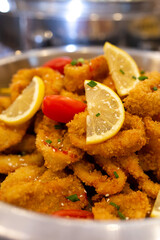 breaded onion rings with lemon close up