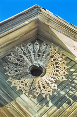 Pediment with decor. Part of an old Russian wooden house.