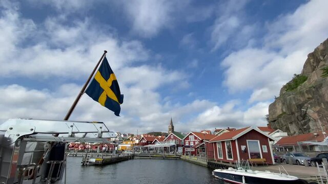 Swaying Swedish national flag in lovely sunny day at the West Sweden coast