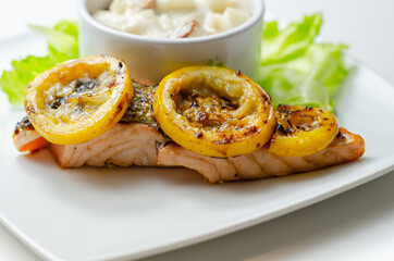 Grilled salmon fillet served with an exquisite salad consisting of cabbage, celery and apple with sultanas and roasted peanuts in mayonnaise