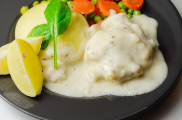 Cod Mornay, flaky cod with a creamy cheese sauce, with mashed potato, peas and carrots