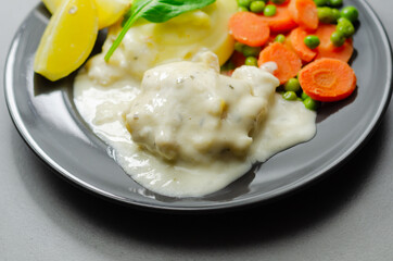 Cod Mornay, flaky cod with a creamy cheese sauce, with mashed potato, peas and carrots