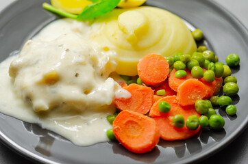 Cod Mornay, flaky cod with a creamy cheese sauce, with mashed potato, peas and carrots