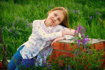 Children's portrait in nature . Beautiful little girl in the countryside
