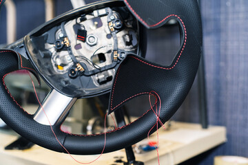 Steering wheel upholstery in imitation leather. A fragment of a dark polyurethane material at the...