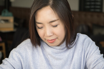 Young adult beautiful black hair Asian woman happy on work while closing the eyes and smile to feel good and relax with success in the work modern office