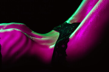 Slim thin female body in underwear. Sexy figure of a girl with neon lighting