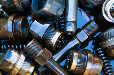 Details of the ship's main engine in oil close-up. Nozzles, bushings, springs and threaded parts.