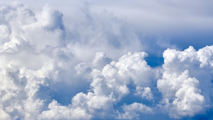 Fototapeta na wymiar White porous clouds on the blue sky, cloudy landscape.