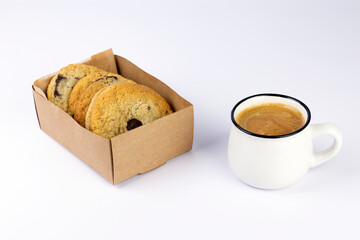 Hot black coffee with foam and sweet chocolate cookies in kraft paper box on white background. Part of set.