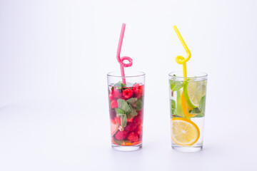 Cocktails isolated on white background. Lemon and lime, mint and raspberries cocktails.