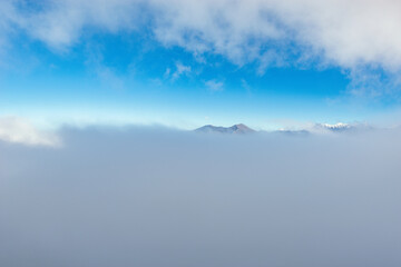 Clouds above the mountain tops at day time.