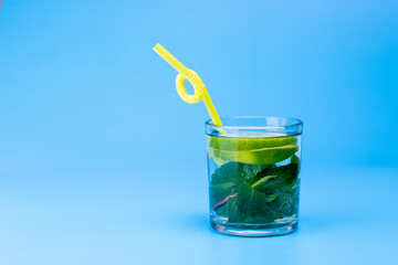 Fresh water in glass with lime and mint on aqua blue background. Part of set.