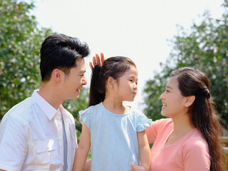 Fototapeta premium Happy family of three in the outdoor group photo