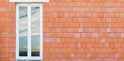 Large plastic window installed in the wall of the house