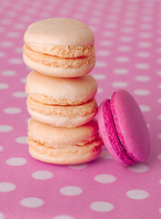 Vanilla macaroons and strawberry cookies on pink background
