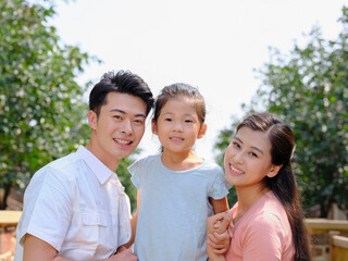 Happy family of three in the outdoor group photo