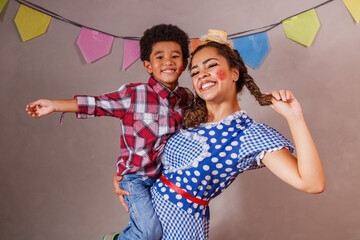 Afro mother and son dressed for June party, Brazilian party called 