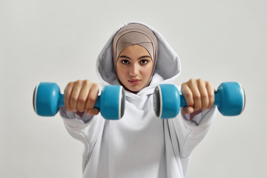 Young Arabian Woman In Hijab Holding Dumbbells