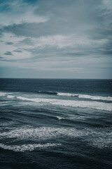 Fototapeta na wymiar Blue ocean with white foamy waves