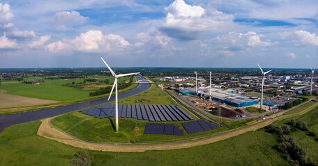 Panoramic view of wind turbines, water treatment and bio energy facility and solar panels in The...