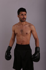 Fototapeta na wymiar Fighter with boxing gloves on grey background