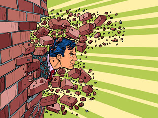 Businessman breaks through a brick wall. The will to overcome obstacles