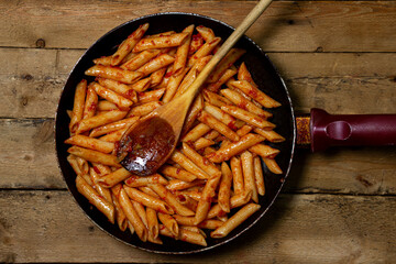 Italian pasta in tomato sauce in a frying pan. Italian penne. homemade food