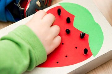 Black cotton ear buds. Little box with strawberry application on it. Fine motoric skills Pin game. Educational game for preschool. 5 minute crafts. DIY home game for children with Kitchen Tools.