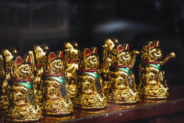 Maneki-Neko Japanese lucky waving beckoning cat in shop window