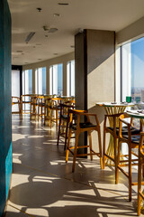 a tables in a restaurant or cafe with a panoramic window on a sunny day
