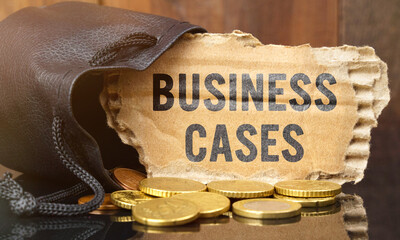 On the table is a bag of money from which sticks out cardboard with the inscription - BUSINESS CASES