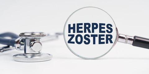 There is a stethoscope on the table, a magnifying glass with the inscription - HERPES ZOSTER