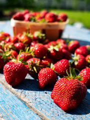 Ripe red strawberries on an old weathered wooden table