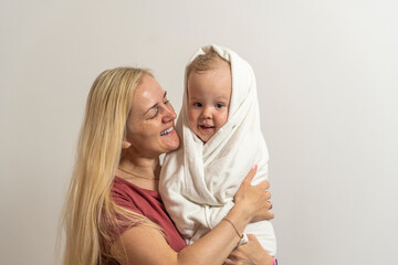 Mom and son with blond hair after bathing