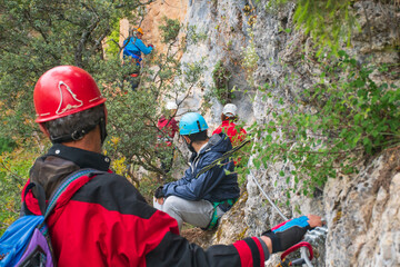 Group of people doing a via ferrata in Alps outdoors