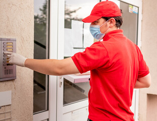 Delivery man wearing red ringing at the doors