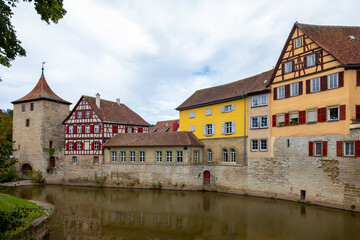 Fototapeta na wymiar Old tower and historic, medieval half-timbered houses in the historic center of Schw bisch Hall on the Kocher river, Baden-Wurttemberg, Germany.