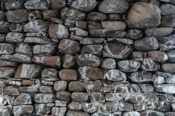 Texture of a stone wall. Old castle stone wall texture background. Stone wall as a background or texture. Part of a stone wall, for background or texture. High quality photo