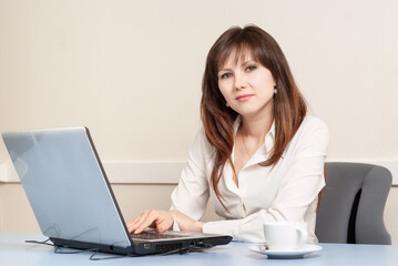 Young woman using laptop in the office