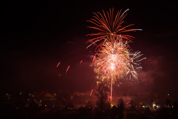 Fireworks ower populated area in new year celebration midnight.