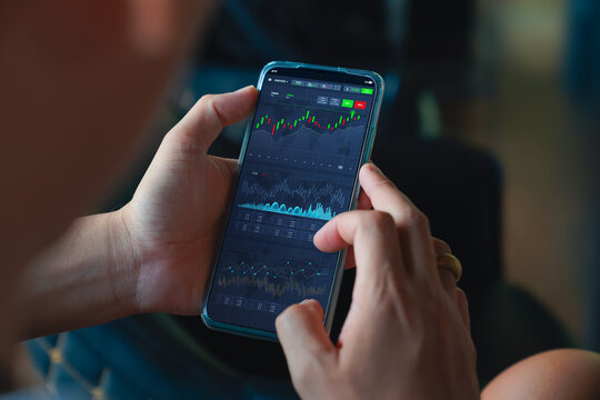 Online stock trading platform concept. Man check invest account dashboard and stock price on online marketplace through mobile phone before buying investment. Financial, Investor analyze investing