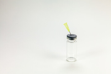 Glass bottle for vaccines on white background