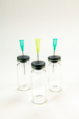 Glass bottle for vaccines on white background