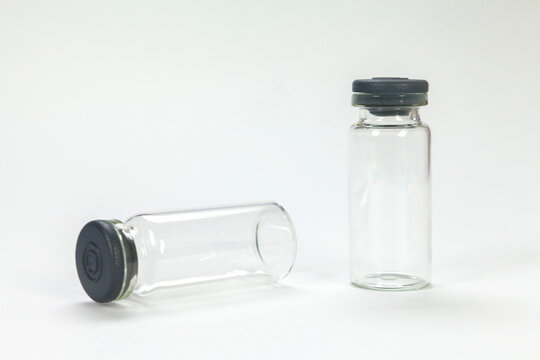 Glass bottle for vaccines on white background